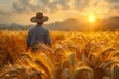 Farmer overlooking wheat field at sunrise