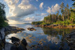 A panoramic photograph capturing the interplay of light and shadow on Heart Island's coastline.