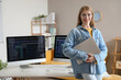 © Pixel-Shot - Female programmer with laptop in office