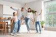© Pixel-Shot - Happy family dancing in kitchen