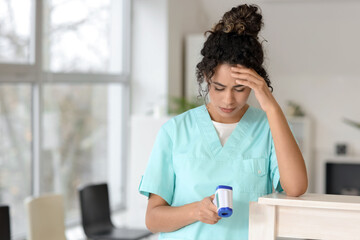 Poster - Female African-American medical intern with infrared thermometer in clinic