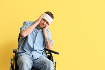 Poster - Young man with brain concussion in wheelchair on yellow background