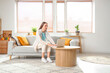© Pixel-Shot - Young pretty woman chatting with laptop on sofa in light living room