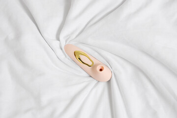 Vibrator on white fabric background