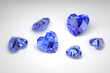 Scattering of blue sapphires of different sizes on a white background. Exhibition of precious stones. Heart cut. 3d rendering.