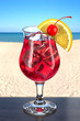 Refreshing cocktail with cherry and orange on wooden table in a beach bar. Picturesque background with sand and sea. Poco Grande glass. 3d rendering.