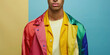 Portrait of young well groomed man and lgbt flag rainbow colors on simple background with copy space. 
