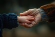© Katsiaryna - Hands of the elderly and the child holding hands.