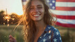 © Erzsbet - portrait of a young woman who celebraty july 4th american independent day standing near a USA flag and hold a sparkler