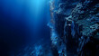 Underwater cliff of a continental shelf, showing a vertical drop and the contrast between shallow water marine life and the deeper ocean's darkness