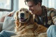 handsome young man playing with golden retriever in stylish apartment pet love