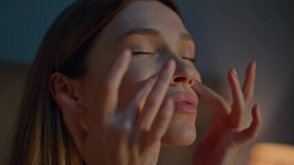 Wall Mural - Woman making facial massage at evening apartment close up. Girl massaging face 