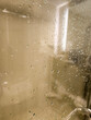 Wet shower stall glass with steam and water drops