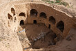 Traditional ancient Berber troglodyte underground dwellings in Tunisian town of Matmata with arched doorways carved into earth