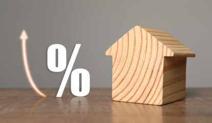 Wall Mural - Mortgage rate. Wooden model of house, arrow and percent sign on table, banner design