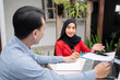 Man and woman business colleagues discussing a business project plan during a meeting