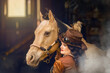 Portrait of a young woman and her palomino horse cosplay dressed in a steampunk outfit