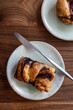© Rachel Weill - Overhead view of a gourmet chocolate babka pastry on white plate at cafe