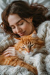 Happy woman snuggling with ginger cat in cozy bed, sharing affectionate moment of comfort