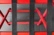 Fabric belts on red wooden planks. Abstract geometric composition. Selective background.