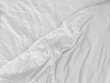 Unmade bedding sheets top view background. White wrinkled blanket after sleeping. Messy duvet. Cozy fabric surface. Untidy bedspread backdrop.