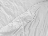 Fototapeta  - Unmade bedding sheets top view background. White wrinkled blanket after sleeping. Messy duvet. Cozy fabric surface. Untidy bedspread backdrop.