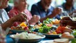 © Lakkhana - A group of people eating a meal of fresh fruits and vegetables. The people are from all walks of life, and they are all enjoying their meal.