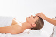 © Acronym - Young woman getting massaging treatment over white. Spa, healthcare and recreation concept.