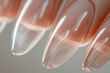 A close up of a person's fingernails with a clear coat of nail polish