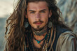 © Keitma - Portrait of a tattooed caucasian nordic young man with long hair an wearing jewelry