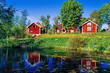 Summer idyll with red cottages by a lake