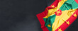 Flag of Grenada. Fabric textured Grenada flag isolated on dark background. 3D illustration