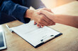 © Pormezz - close up view hands of agent and client shaking hands after signed contract buy new apartment.