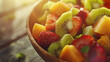 A refreshing fruit salad with mixed fruits in a bowl, illuminated by sunlight