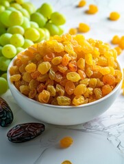 Dried yellow grapes in a bowl with fresh green organic grapes.