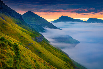 Wall Mural - dramatic morning view of faroe islands with huge fog on fjord, denmark, europe. fantastic summer sce