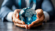 © PhotoGranary - Business professional cradling a glowing glass globe, symbolizing global business and environmental care.