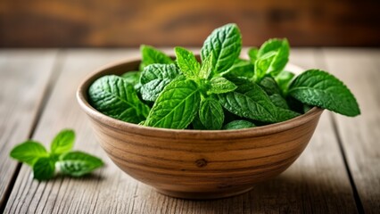  Fresh mint leaves in a wooden bowl