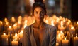 Serene woman basks in a cozy glow, encircled by numerous candles, evoking a sense of rejuvenation and revitalization