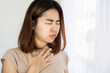 Asian woman suffering from nausea and vomiting, foodborne illness concept