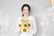 Cute bride with sunflower bouquet Bridal, beauty and pre-shoot images Looking at the camera