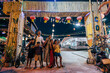 © Maskot - Portrait of happy family showing peace sign while standing at entrance of food market