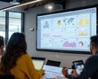 © wudu_8 - A conference room projector showing a vibrant dashboard with various charts. Participants take notes