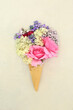 Surreal summer flowers and herbs in ice cream cone. Natural alternative adaptogen tranquilizing floral ingredients used in herbal medicine treatments on hemp paper background.
