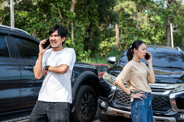 Asian man and woman drivers arguing after traffic collision accident feeling serious and stressed. Parked on side way road Call Emergency assistance or insurance claim service. Car Crash