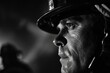 Dramatic black and white portrait of a male firefighter looking intently, his face illuminated by backlight in a dark setting, highlighting the intense and heroic nature of his profession.