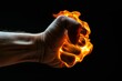 Man's flaming fist on a black background, showing anger and strength.