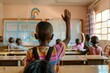 © senyumanmu - boy raising hand while answering in class at elementary school