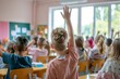 © senyumanmu - boy raising hand while answering in class at elementary school