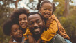 © Mangata Imagine - Happy family with children, dad and mom giving piggyback ride to kids smiling outdoors in a park